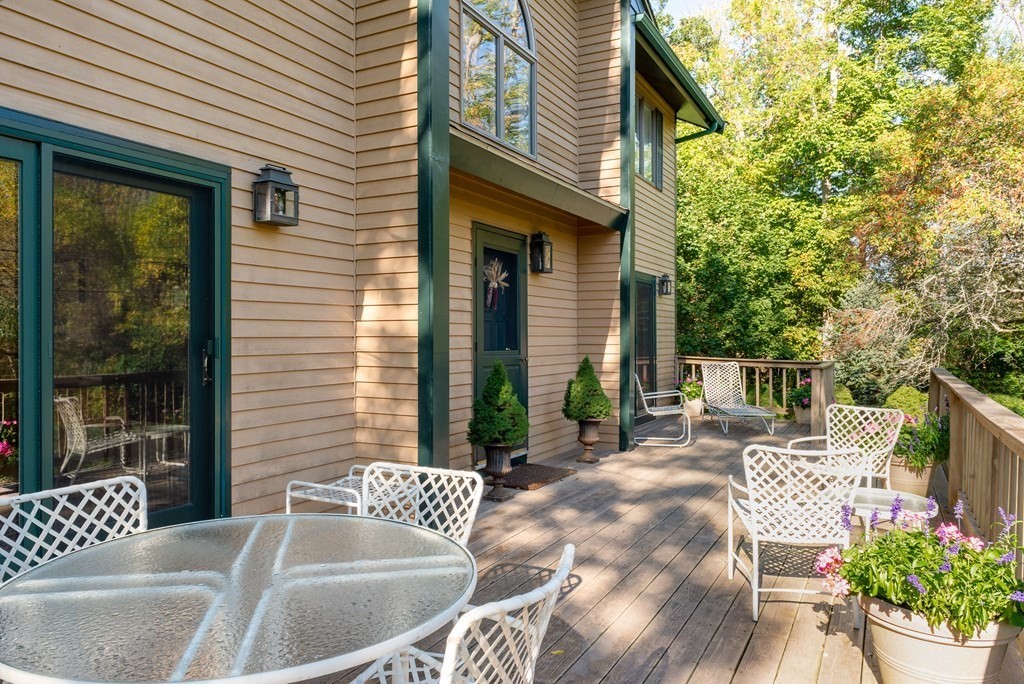 239 Argilla Road Ipswich, MA 01938 - Photo 32 of 37 a view of a patio with couches table and chairs and potted plants