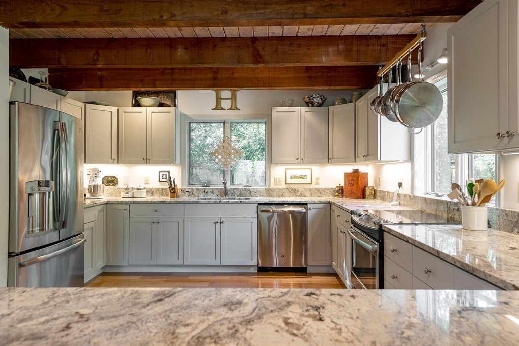 239 Argilla Road Ipswich, MA 01938 - Photo 7 of 37 a kitchen with stainless steel appliances granite countertop a sink stove and refrigerator