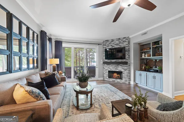 a living room with furniture a fireplace and a flat screen tv