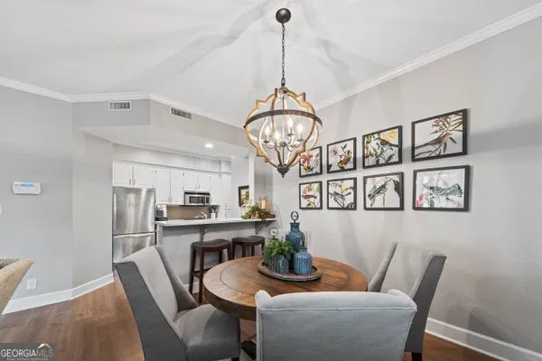 a view of a dining room with furniture window and wooden floor