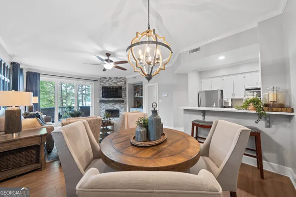 a view of a dining room with furniture a chandelier and wooden floor