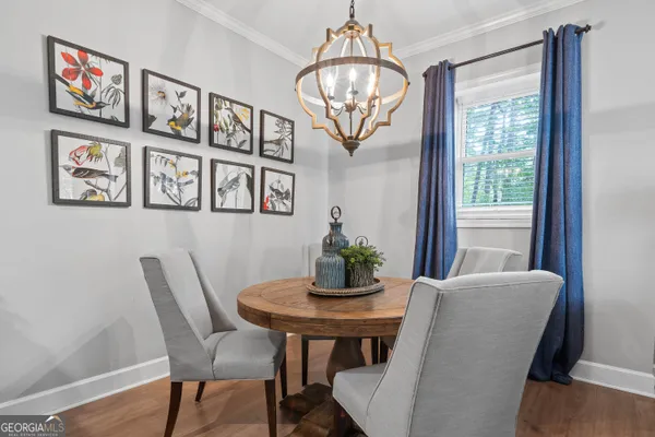 a view of a dining room with furniture wooden floor and chandelier