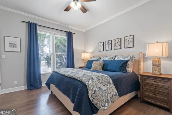 a bedroom with a large bed and a chandelier