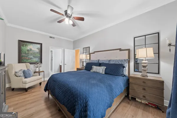 a bedroom with a bed a couch and dresser