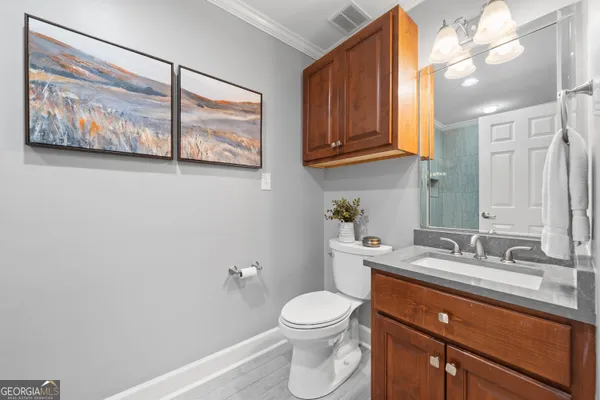 a bathroom with a toilet a sink and mirror