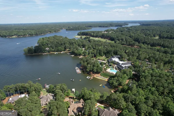 an aerial view of a houses with outdoor space and lake view