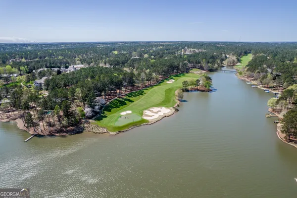 an aerial view of a house with a garden and lake view