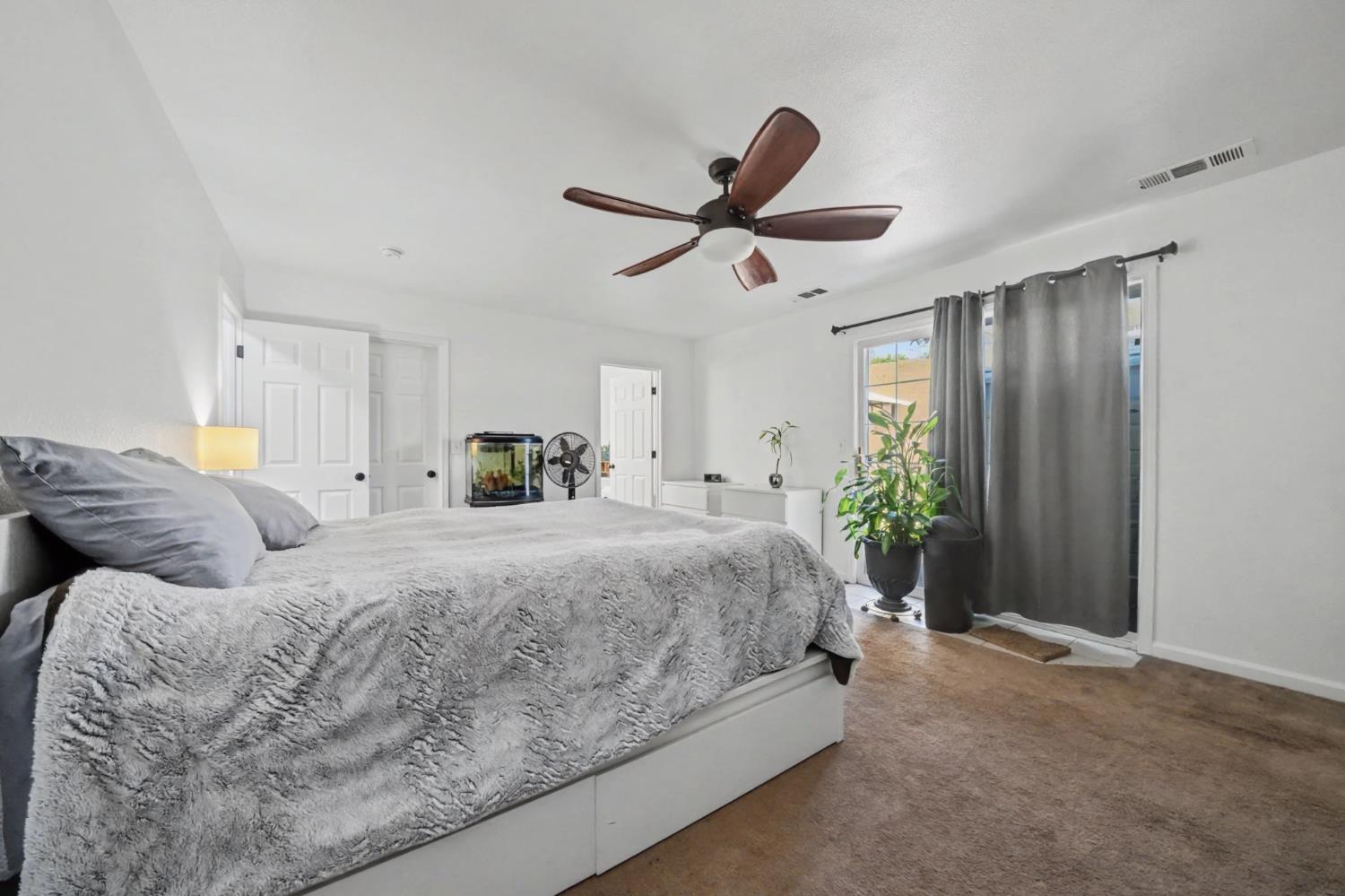 7761 Jenny Lind Road Valley Springs, CA 95252 - Photo 20 of 35 a bed room with a bed and a chandelier