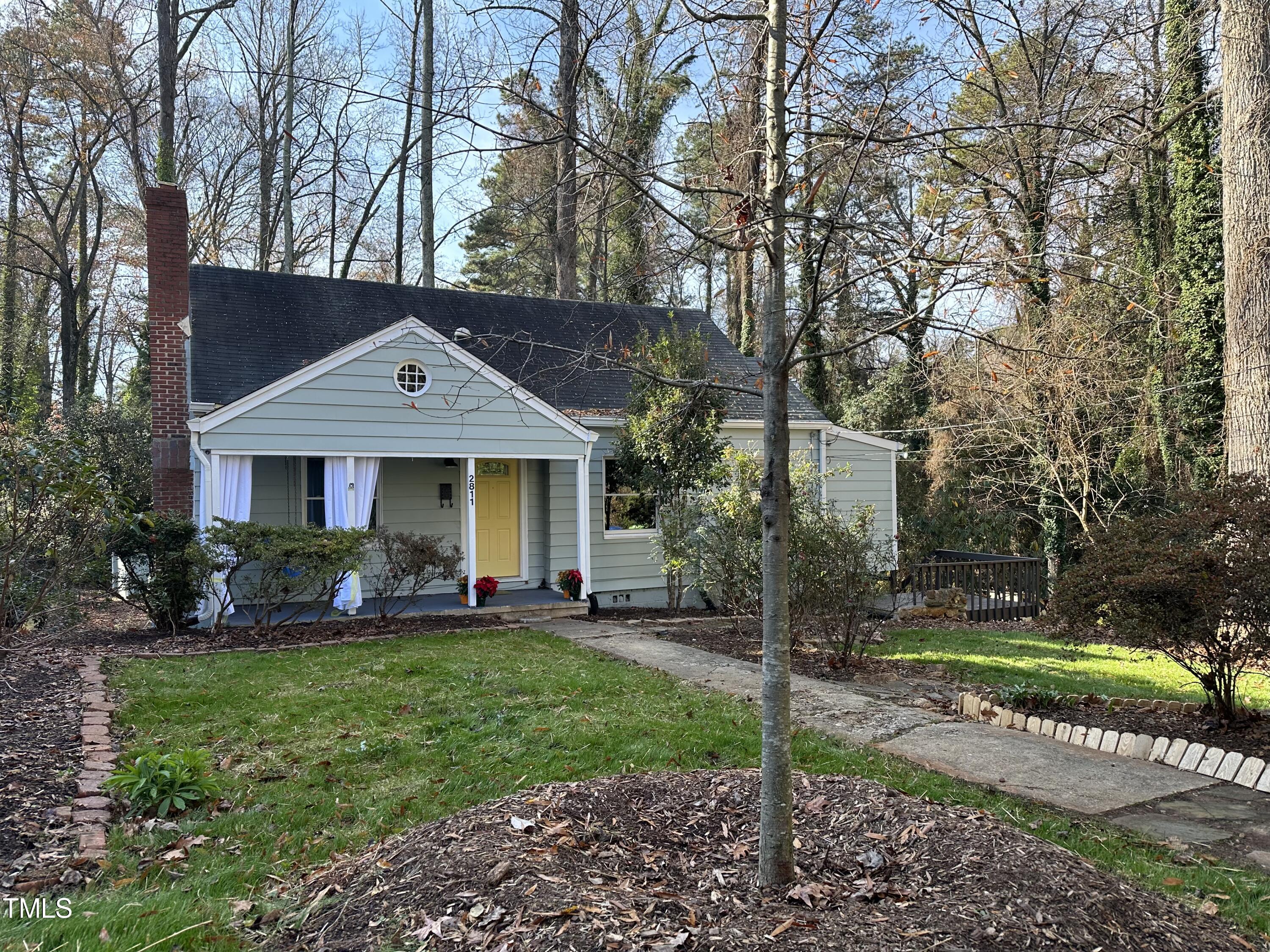 2811 Gordon Street Raleigh, NC 27608 - Photo 1 of 33 a front view of a house with a yard garden and trees