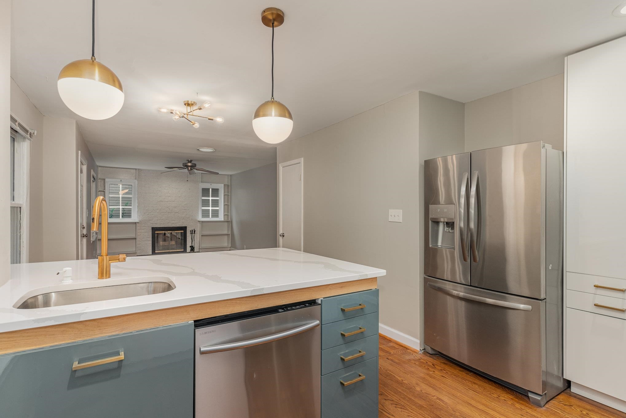 2811 Gordon Street Raleigh, NC 27608 - Photo 19 of 33 a kitchen with kitchen island a sink stainless steel appliances and cabinets
