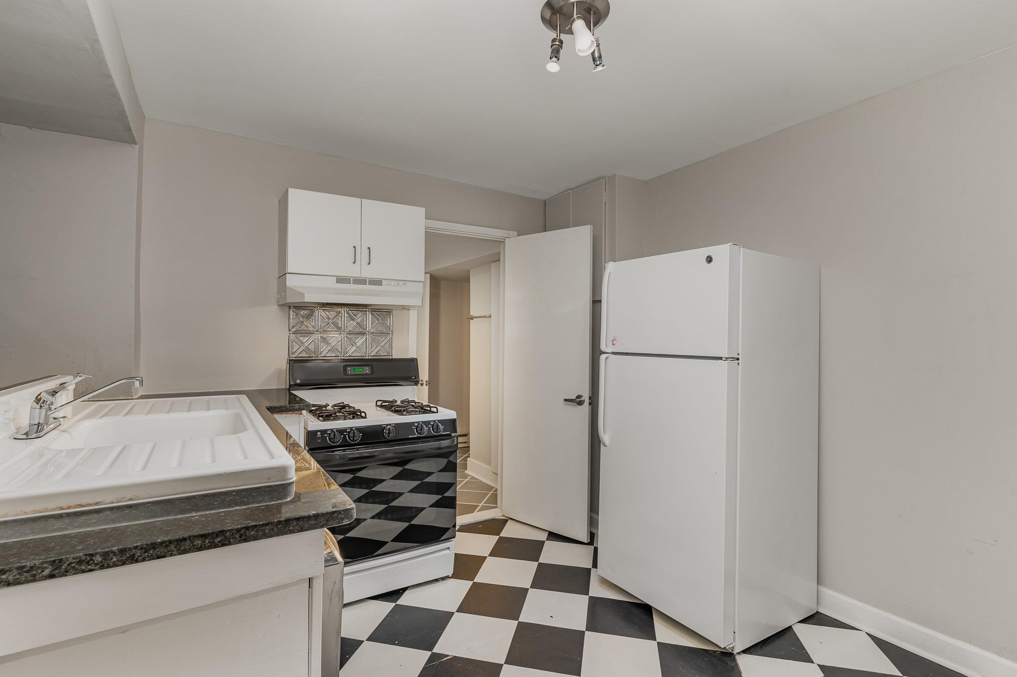 2811 Gordon Street Raleigh, NC 27608 - Photo 31 of 33 a kitchen with a refrigerator and a stove top oven
