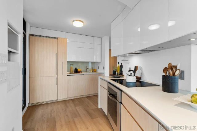 a kitchen with counter top space cabinets and wooden floor