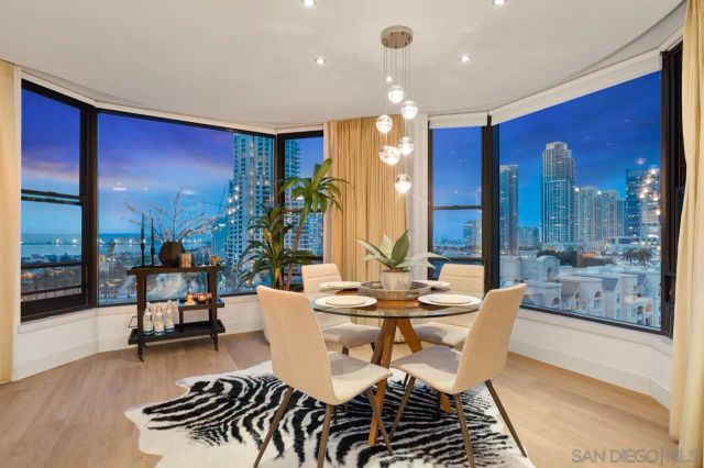 a living room with furniture and large windows