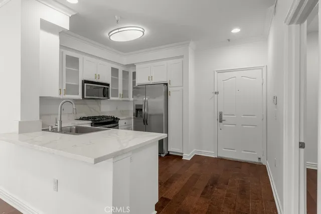 a view of a room with wooden floor
