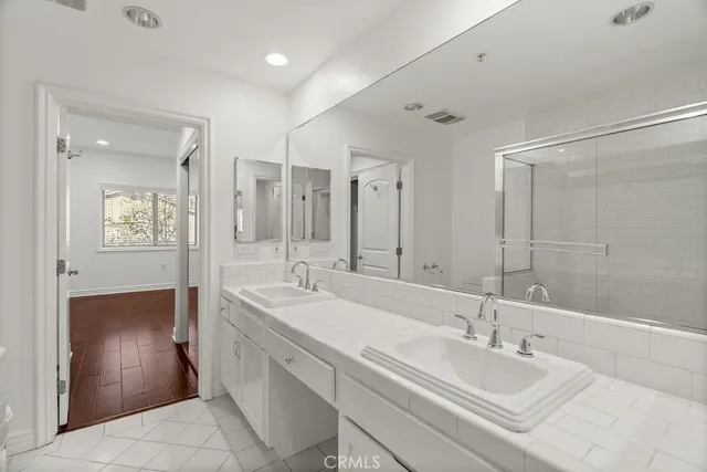 a bathroom with a sink a mirror and a bathtub