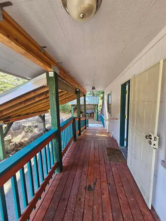 a view of a hallway view with wooden floor and staircase