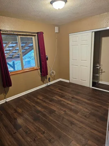 a view of a room with wooden floor and window