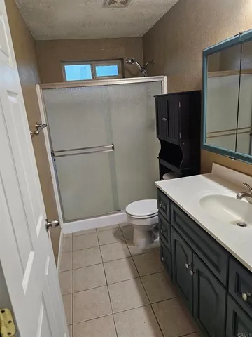 a bathroom with a sink a toilet a mirror and vanity
