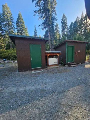 a view of a backyard with large trees