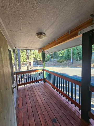 a view of a porch with wooden floor