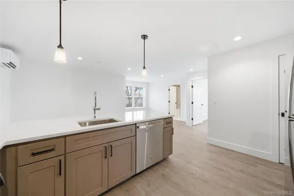 a kitchen with a sink and chandelier