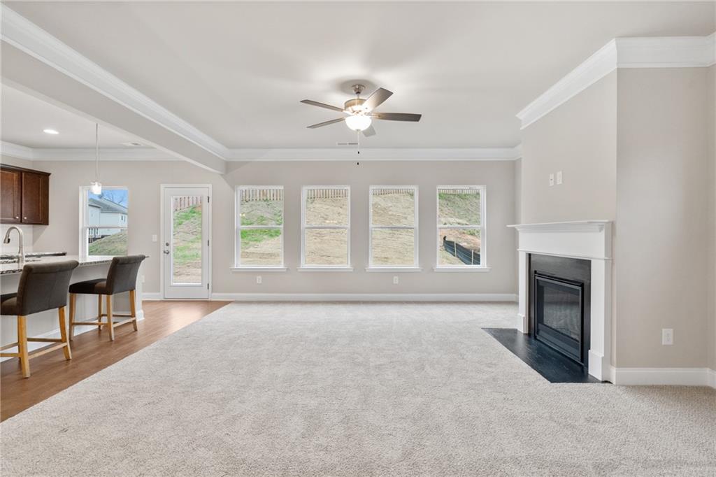 5571 Overview Drive Flowery Branch, GA 30542 - Photo 13 of 38 a living room with furniture and a fireplace