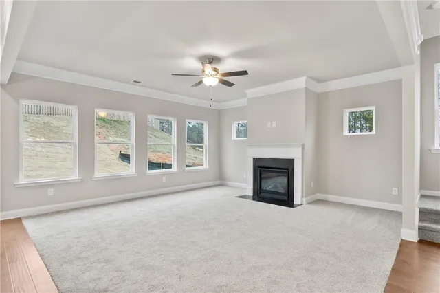 wooden floor fireplace and windows in an empty room