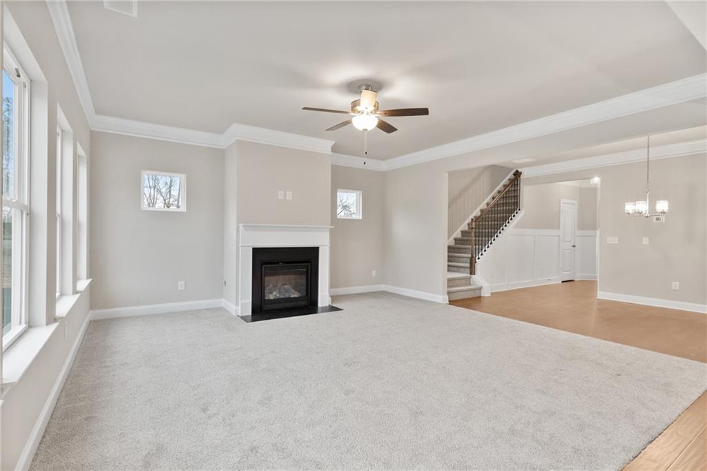 5571 Overview Drive Flowery Branch, GA 30542 - Photo 15 of 38 an empty room with windows and fireplace