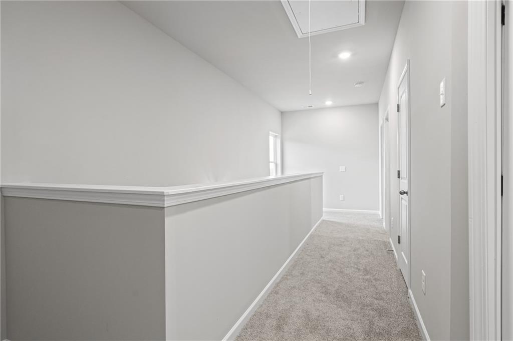 5571 Overview Drive Flowery Branch, GA 30542 - Photo 18 of 38 a view of a hallway with wooden floor