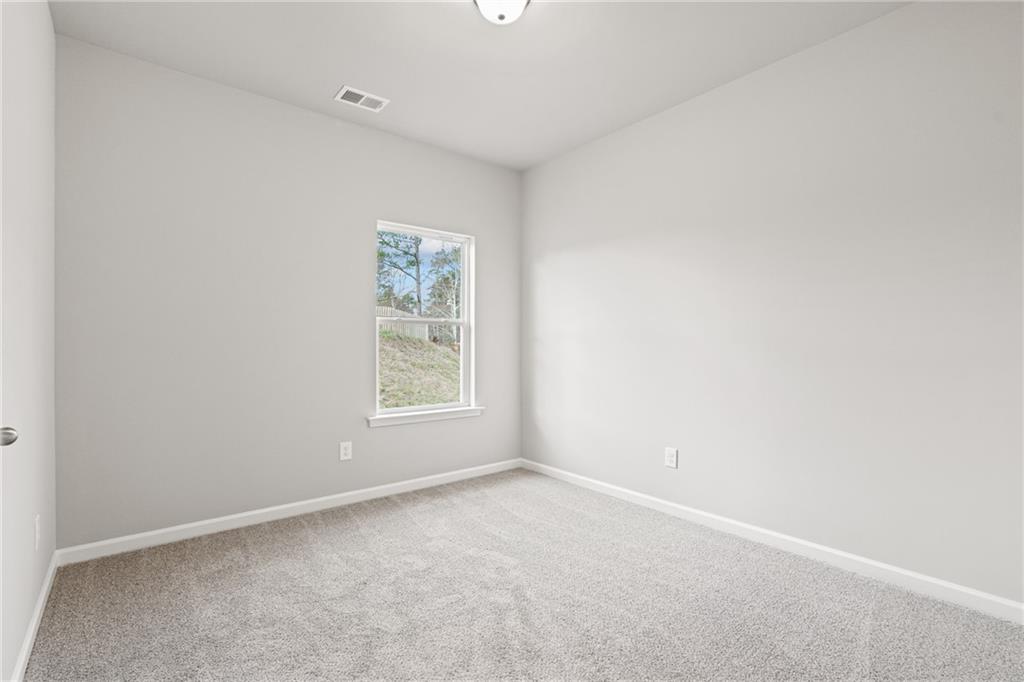 5571 Overview Drive Flowery Branch, GA 30542 - Photo 20 of 38 an empty room with a window