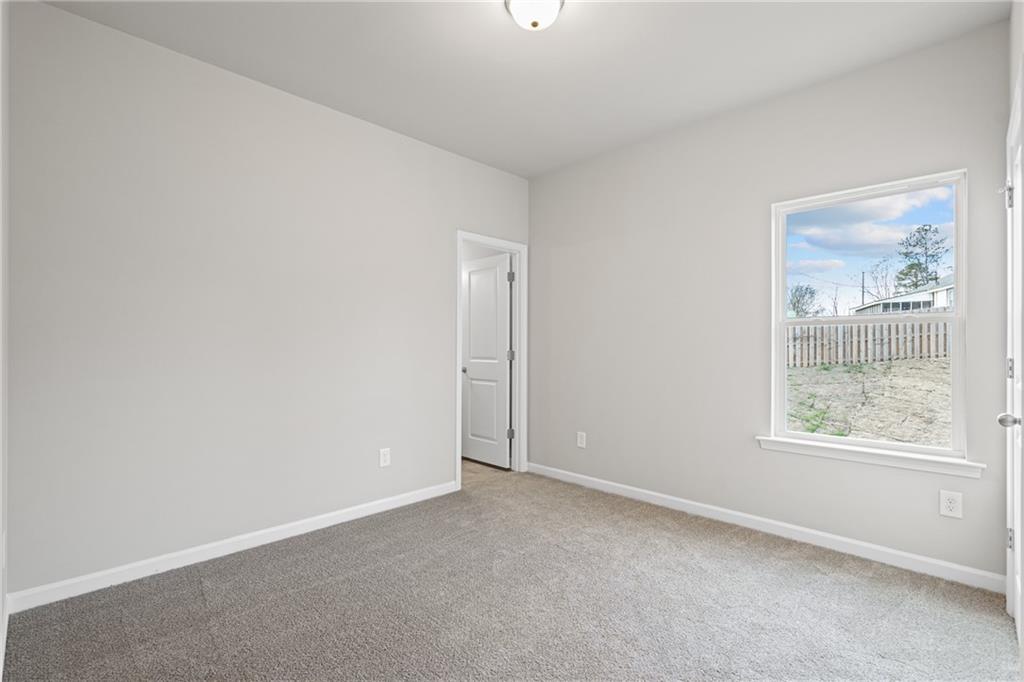 5571 Overview Drive Flowery Branch, GA 30542 - Photo 22 of 38 an empty room with windows