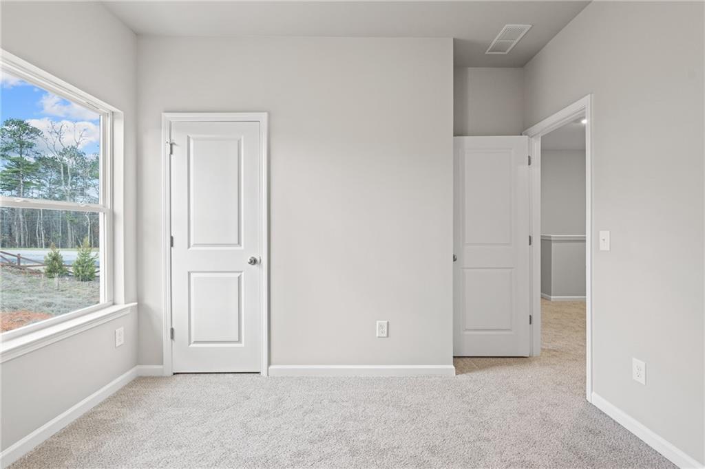 5571 Overview Drive Flowery Branch, GA 30542 - Photo 23 of 38 an empty room with windows and closet