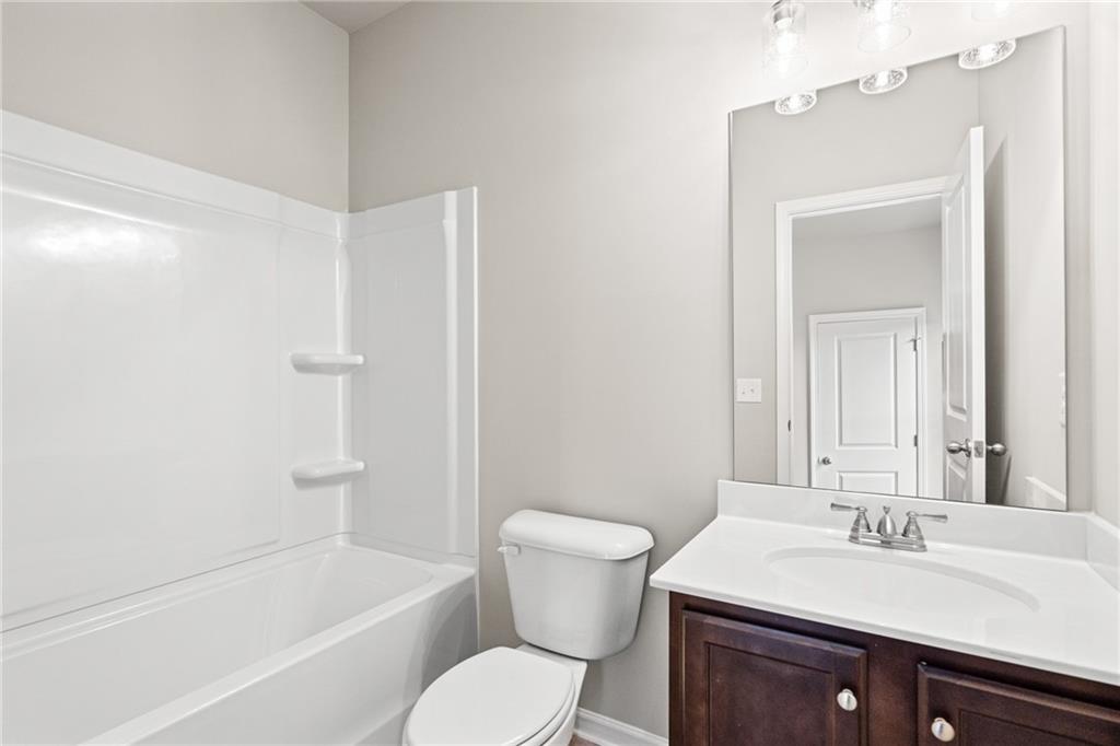 5571 Overview Drive Flowery Branch, GA 30542 - Photo 24 of 38 a bathroom with a sink a toilet and shower