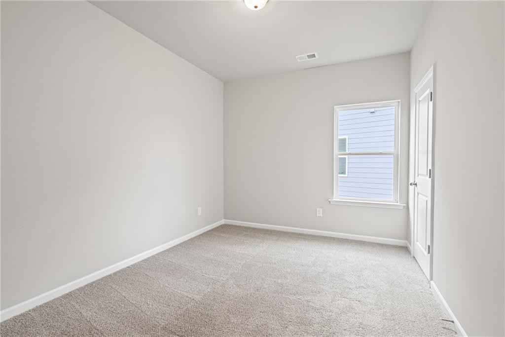 5571 Overview Drive Flowery Branch, GA 30542 - Photo 25 of 38 a view of an empty room with a window