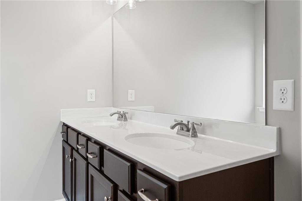 5571 Overview Drive Flowery Branch, GA 30542 - Photo 34 of 38 a bathroom with a sink and a mirror