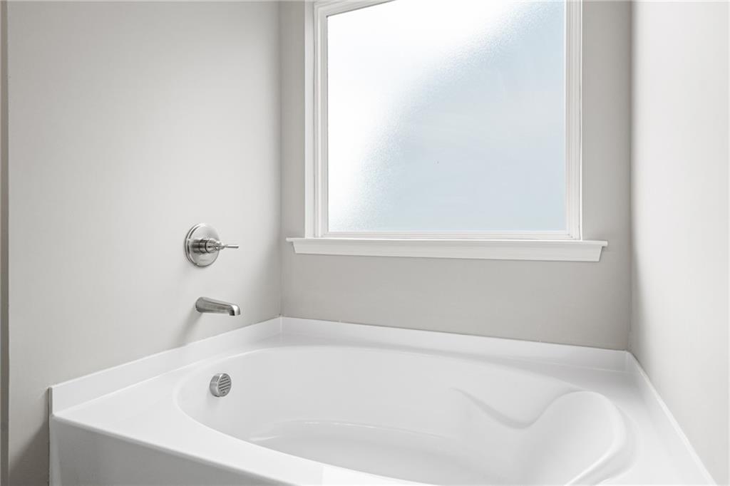 5571 Overview Drive Flowery Branch, GA 30542 - Photo 35 of 38 a white bath tub sitting next to a window