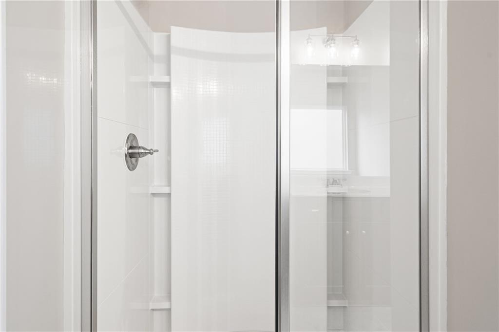 5571 Overview Drive Flowery Branch, GA 30542 - Photo 36 of 38 a bathroom with a glass shower door