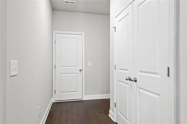 a view of a room with wooden floor