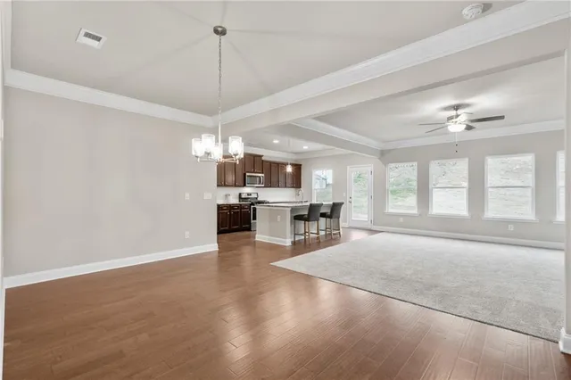 a view of a livingroom with furniture wooden floor and a window