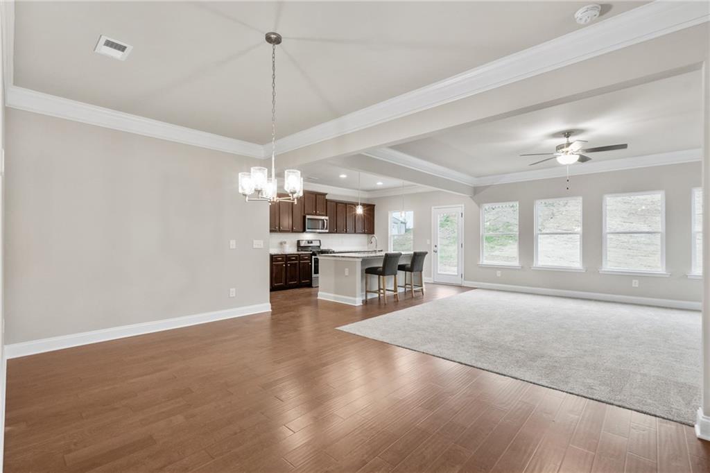 5571 Overview Drive Flowery Branch, GA 30542 - Photo 10 of 38 a view of a livingroom with furniture wooden floor and a window