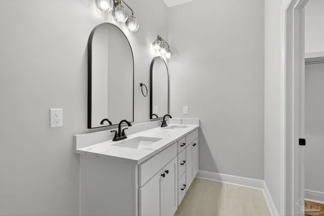 a bathroom with a sink toilet vanity and shower