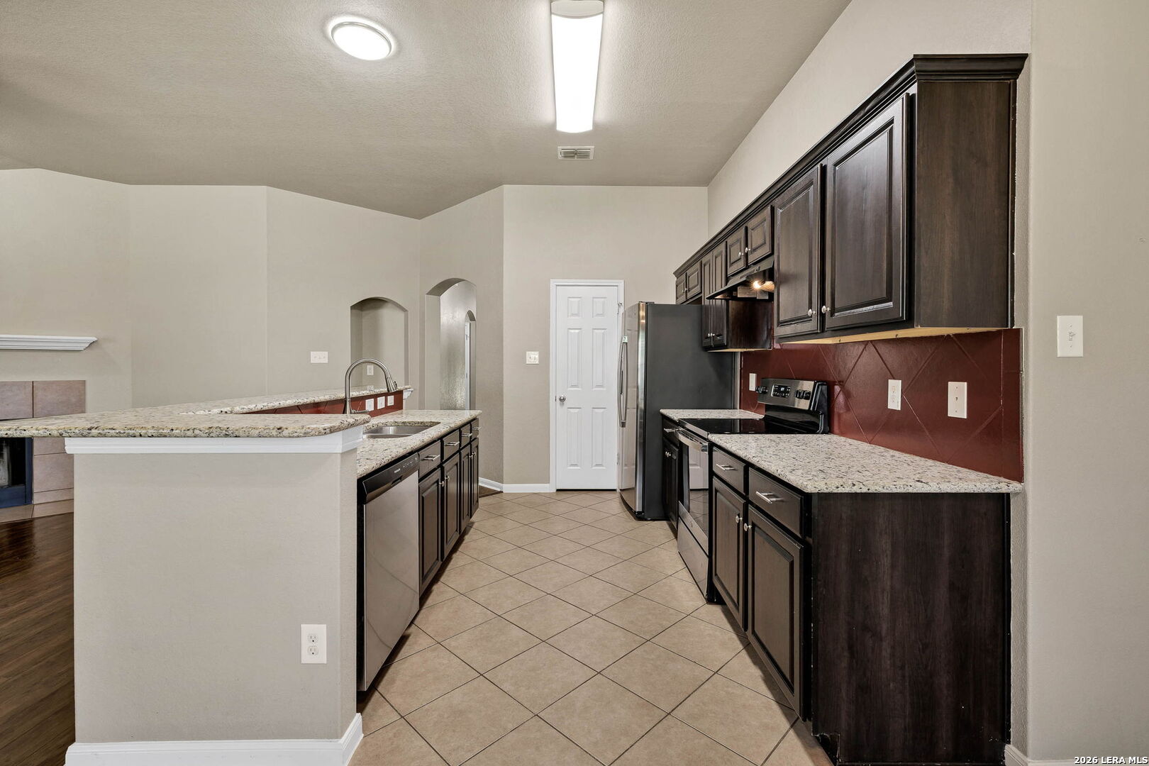 4015 Shervin Way Converse, TX 78109 - Photo 15 of 43 a kitchen with granite countertop a sink and a stove