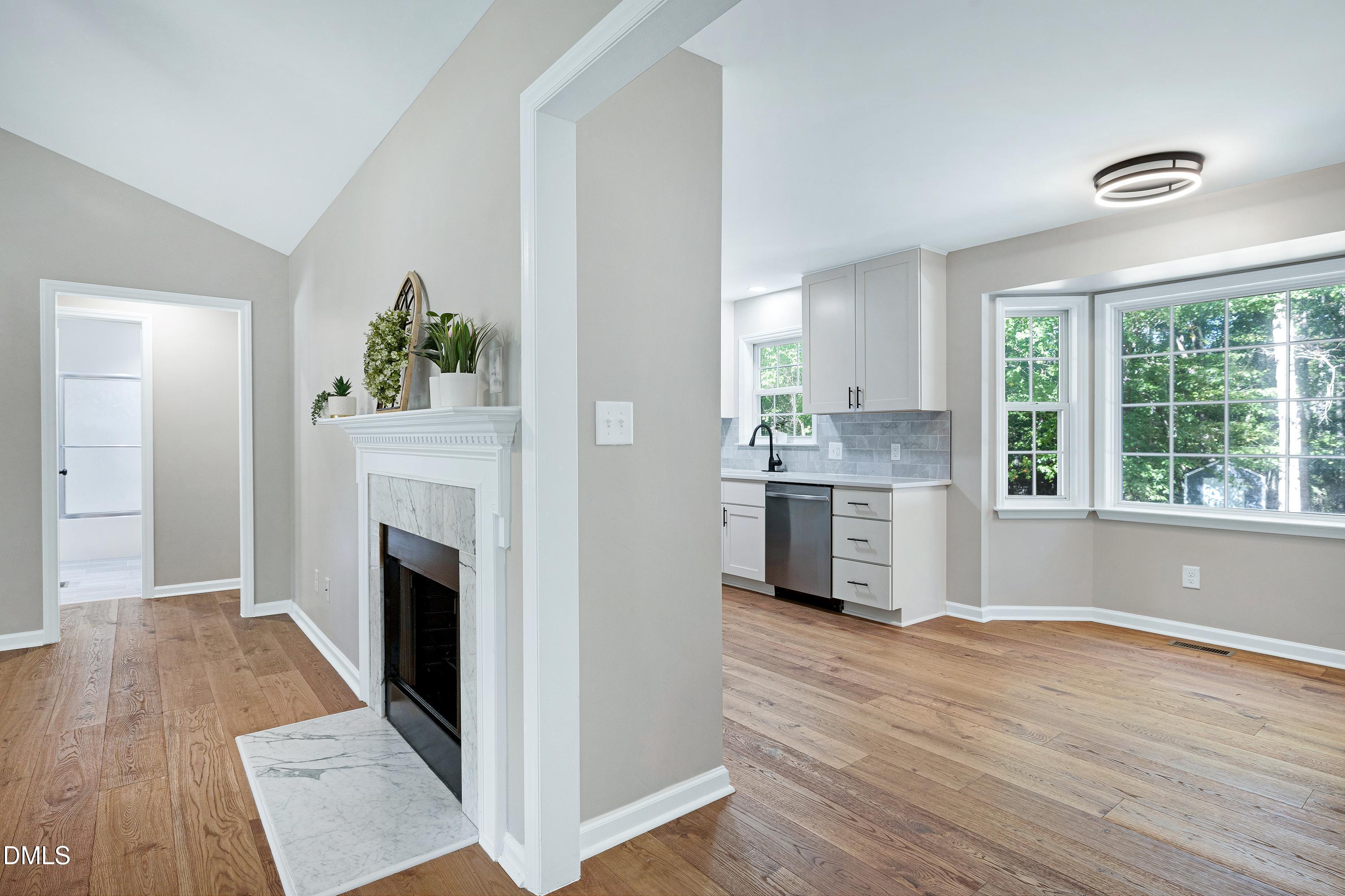 1508 Middle Ridge Drive Willow Spring, NC 27592 - Photo 11 of 56 a open kitchen with granite countertop a stove and a wooden floors
