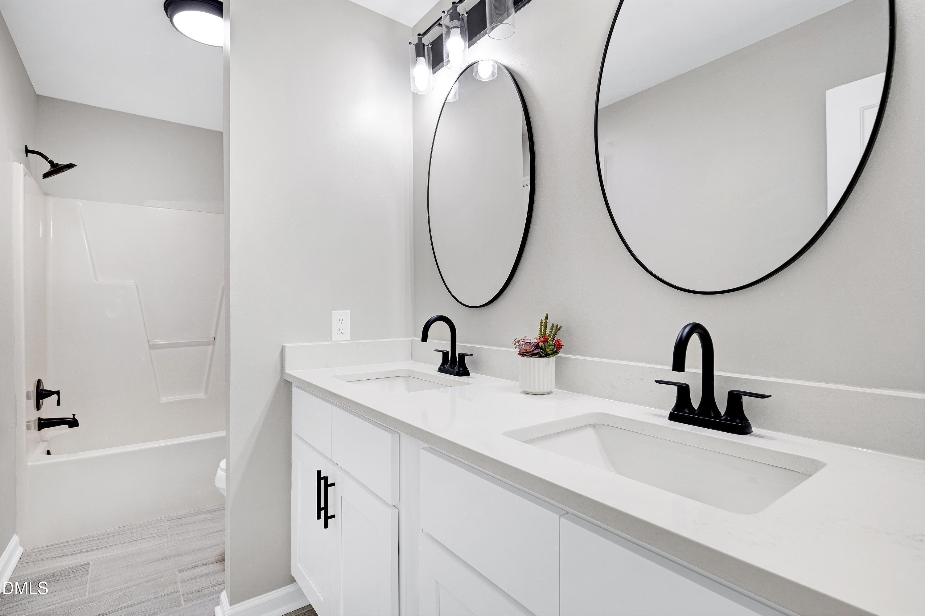 1508 Middle Ridge Drive Willow Spring, NC 27592 - Photo 23 of 56 a bathroom with a sink and a mirror