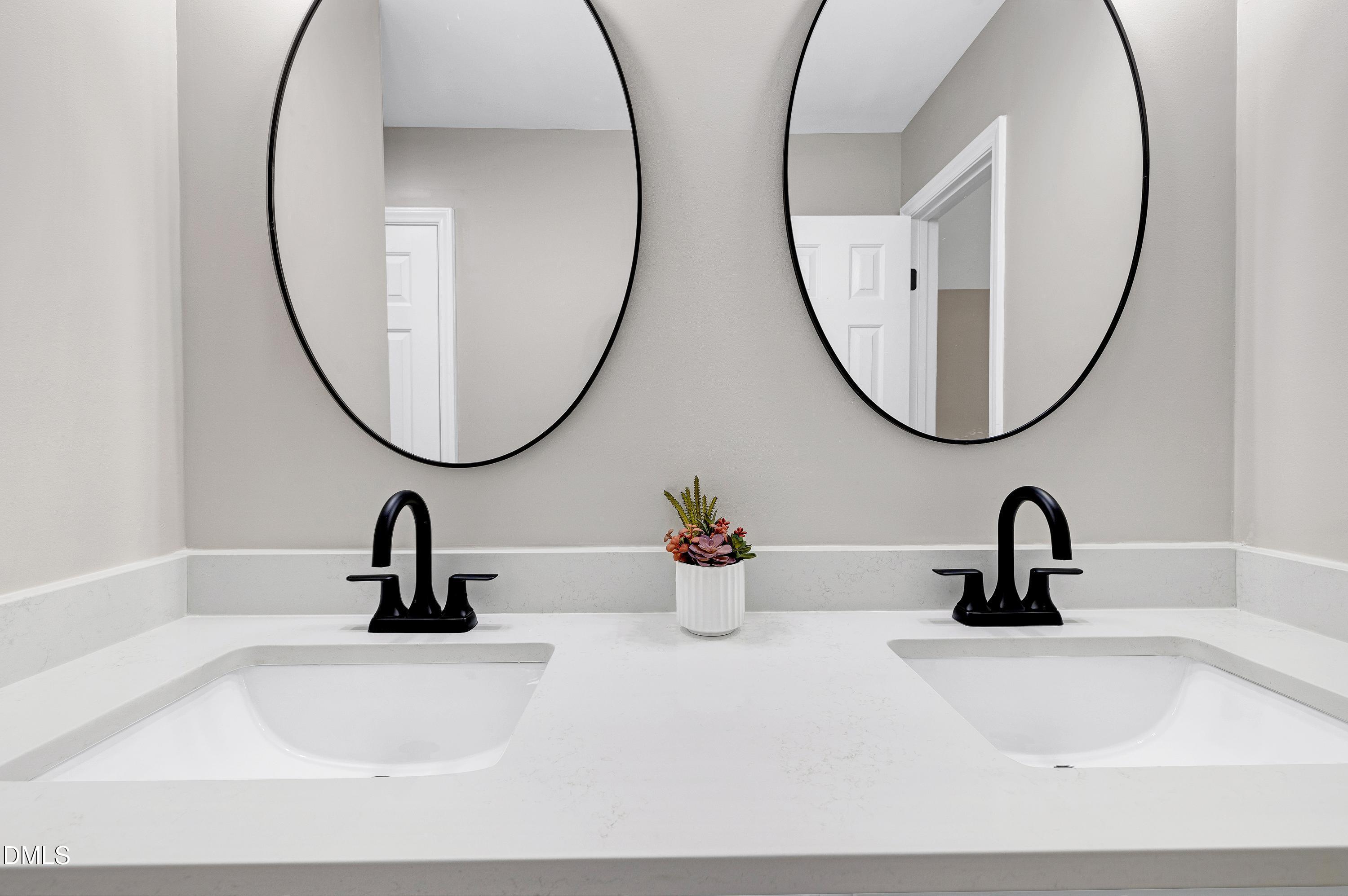 1508 Middle Ridge Drive Willow Spring, NC 27592 - Photo 25 of 56 a bathroom with a sink and a mirror