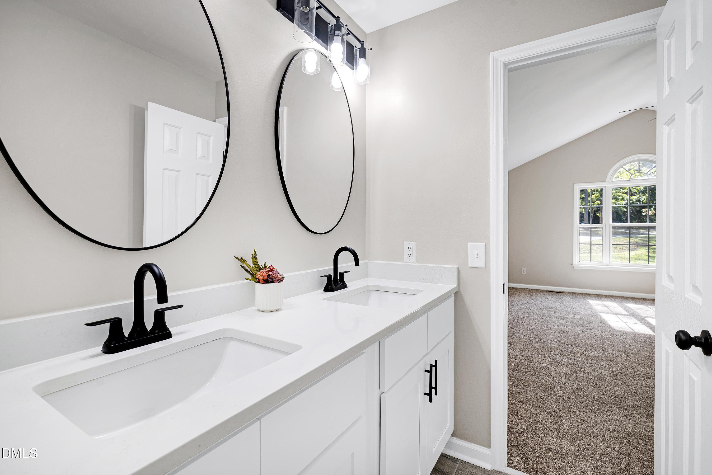 1508 Middle Ridge Drive Willow Spring, NC 27592 - Photo 26 of 56 a bathroom with a sink and a mirror