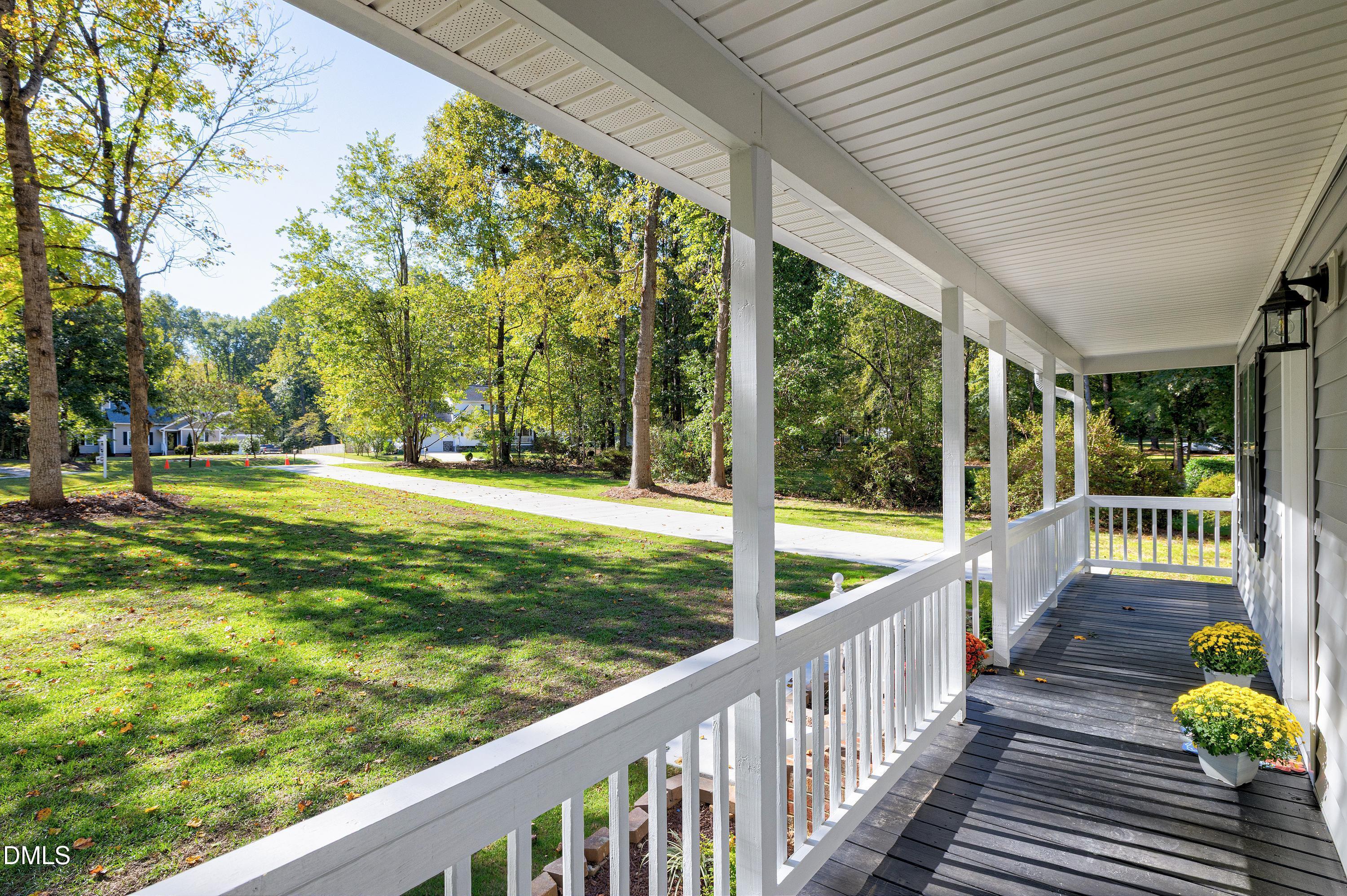 1508 Middle Ridge Drive Willow Spring, NC 27592 - Photo 3 of 56 a view of a porch with wooden floor and fence