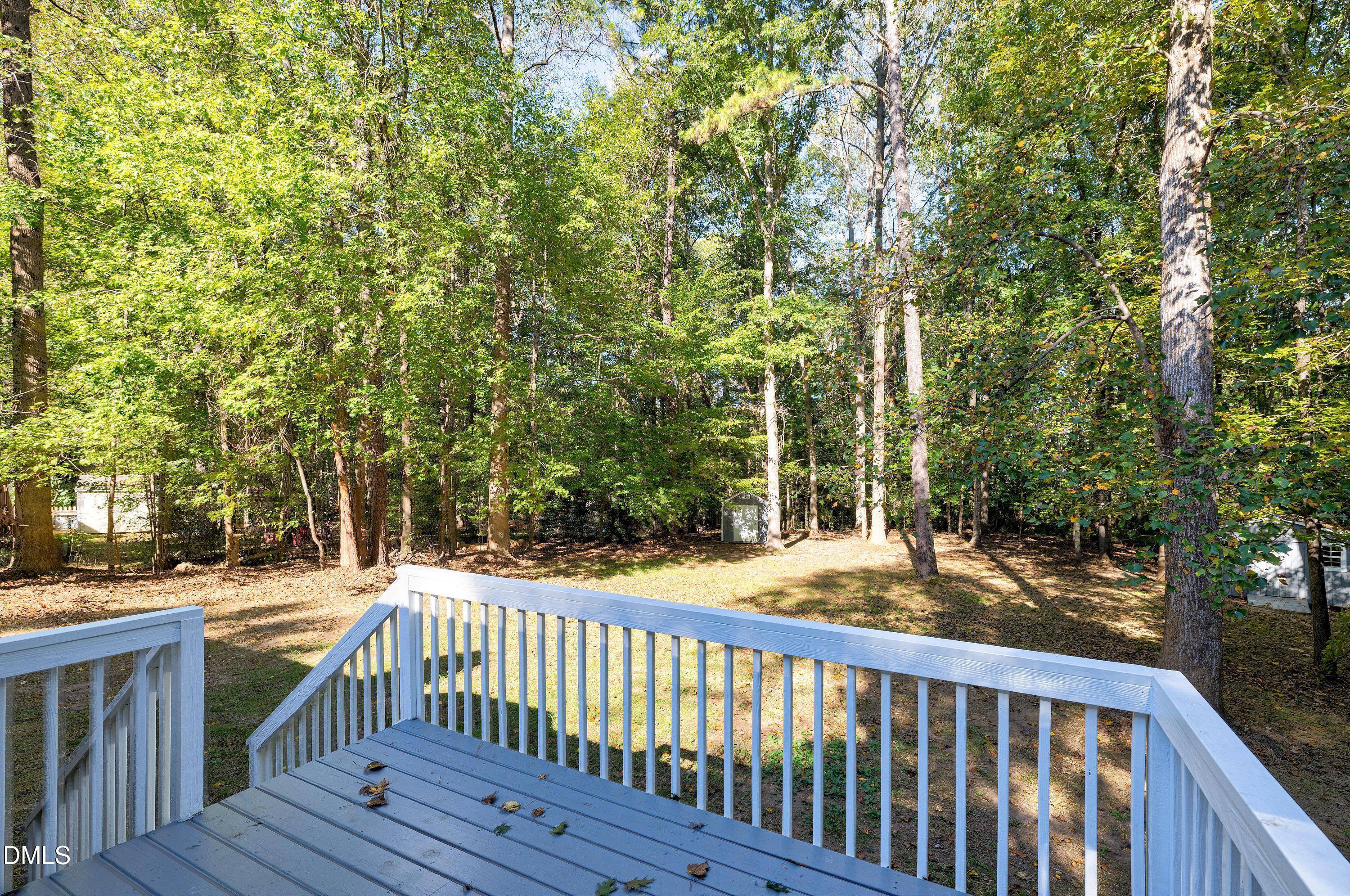 1508 Middle Ridge Drive Willow Spring, NC 27592 - Photo 35 of 56 a view of deck and yard with wooden fence and trees