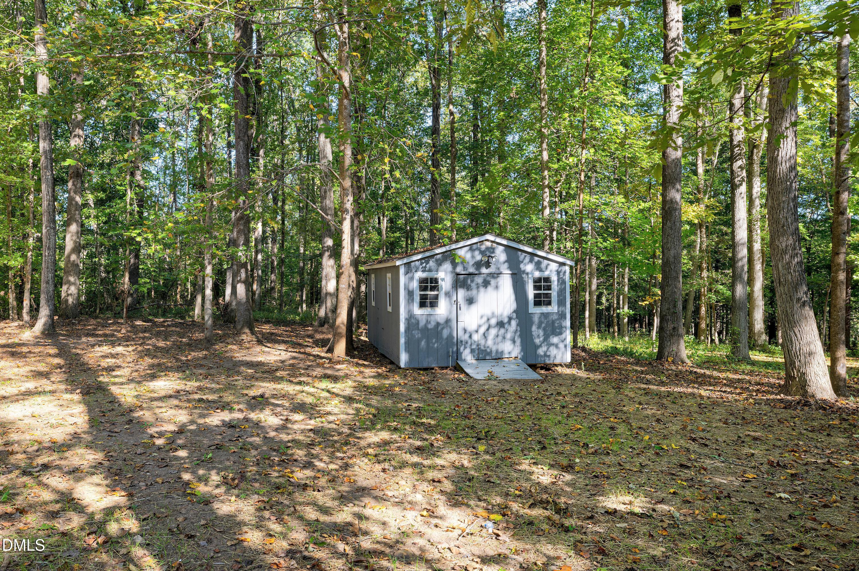 1508 Middle Ridge Drive Willow Spring, NC 27592 - Photo 37 of 56 a view of a barn in the middle of a yard