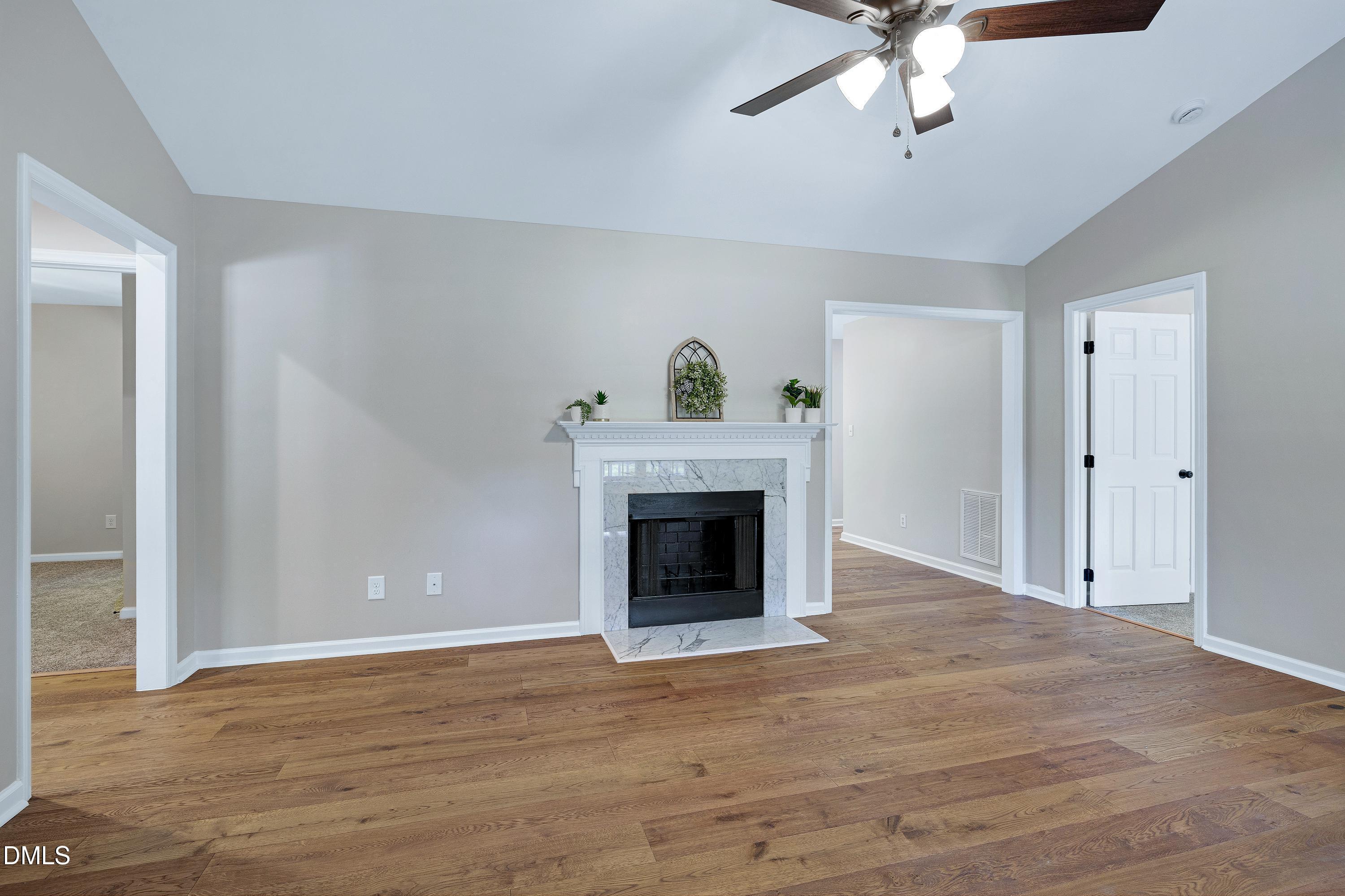 1508 Middle Ridge Drive Willow Spring, NC 27592 - Photo 6 of 56 a view of a livingroom with a fireplace a chandelier and windows